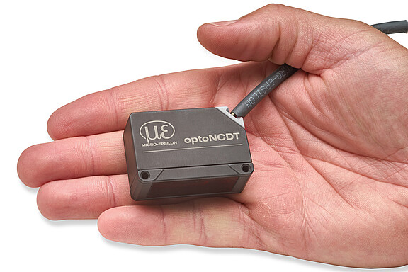 optoNCDT 1320 laser sensor in the palm of a hand